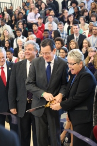 Governor Dannel Malloy and Connecticut River Academy Principal Linda Dadona cut the ribbon on the new school. Goodwin President Mark Scheinberg stands nearby.